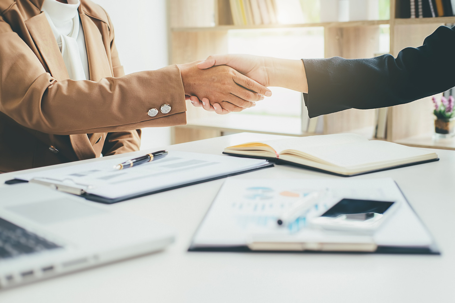Photography of Two People Handshaking